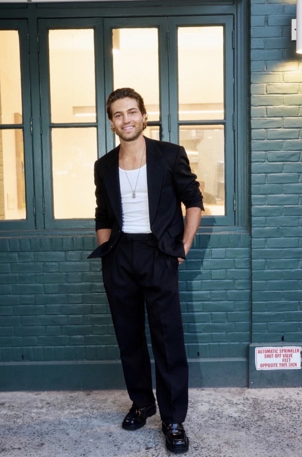 TJ Palma smiling in a Select Vintage suit