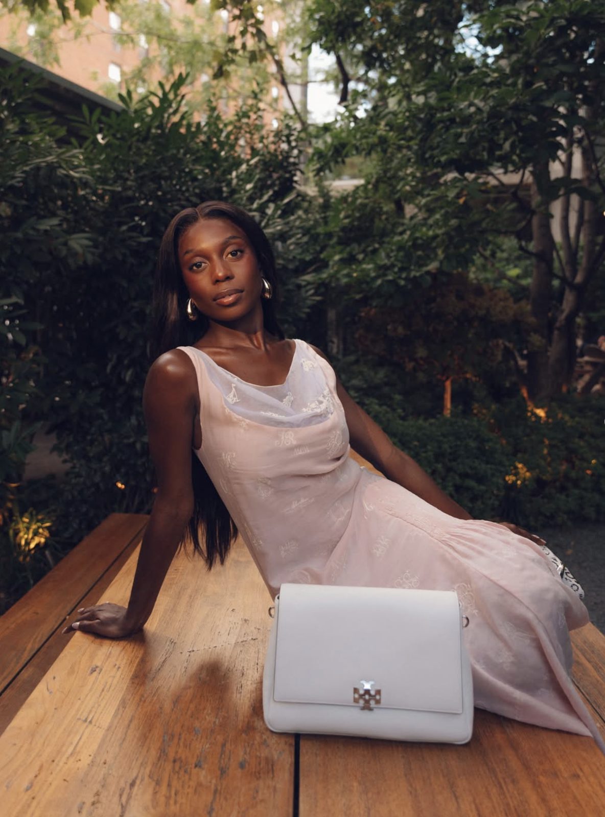 Toni Bravo in a vintage Tory Burch dress with a white Tory Burch bag